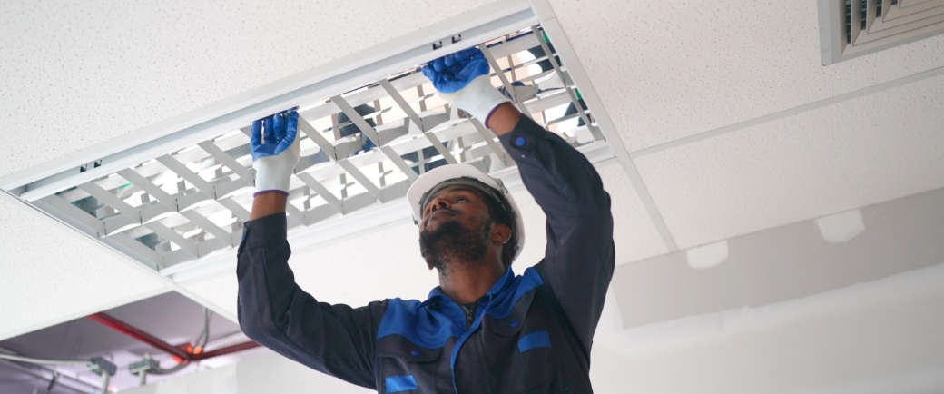 Man working on a ceiling light fixture