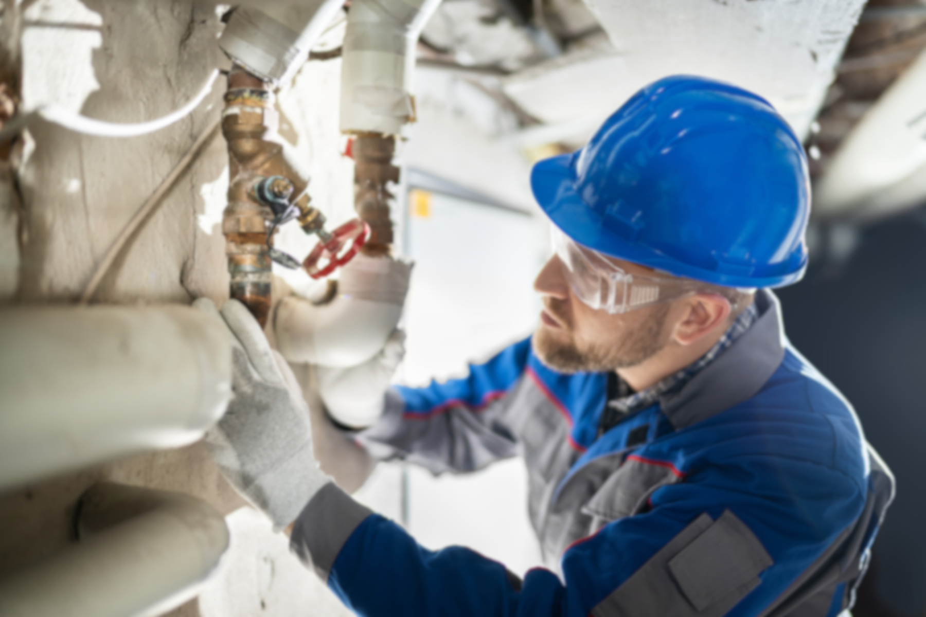 Powerhouse - Commercial Facility Plumbing Inspection and Maintenance Services Commercial plumbing technician performing pipe inspection and maintenance in a retail facility